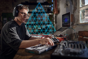 A producer wearing Sennheiser headphones is using EXOVERB MICRO on his laptop to create stereo productions with an immersive fingerprint.
