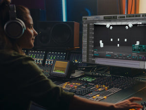 Woman uses the immersive headphone mixing plugin dearVR MONITOR in AVID ProTools with Neumann headphones